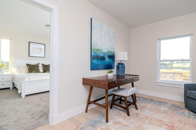 office space with wood finished floors and baseboards