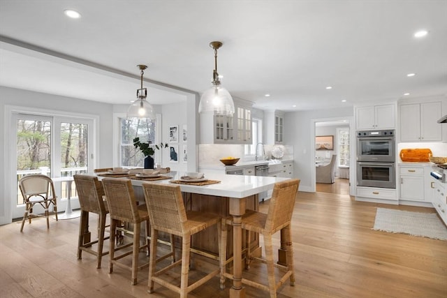 dining area with recessed lighting and light wood-type flooring