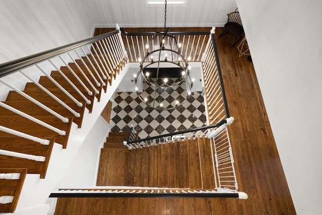 stairs with a notable chandelier