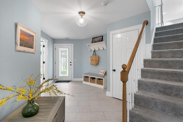 mudroom featuring light tile patterned flooring and baseboards