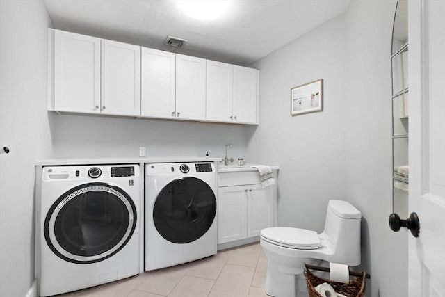 laundry room with a sink, visible vents, washing machine and dryer, and light tile patterned floors
