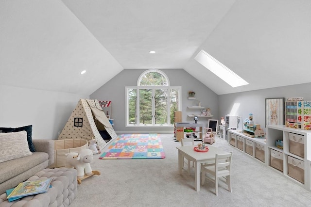 playroom with carpet floors and lofted ceiling with skylight