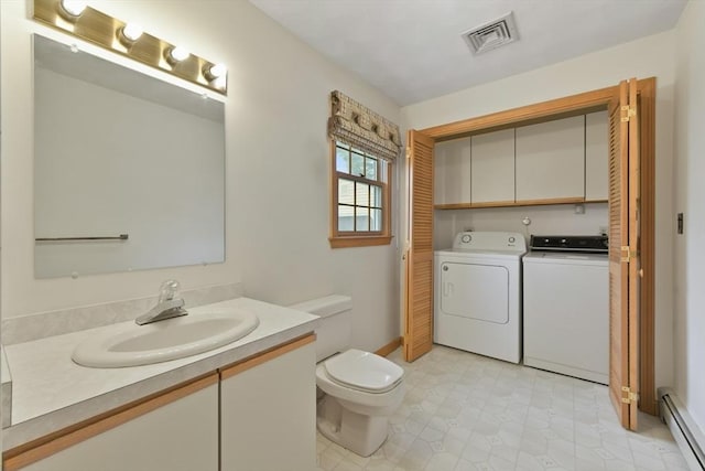 bathroom with visible vents, vanity, a baseboard radiator, toilet, and separate washer and dryer