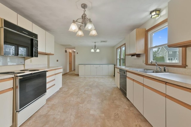 kitchen with hanging light fixtures, an inviting chandelier, black microwave, electric stove, and dishwashing machine