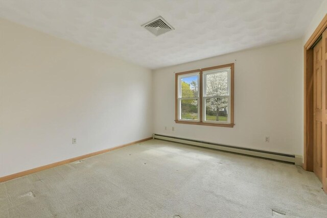 unfurnished room featuring light colored carpet, baseboards, visible vents, and baseboard heating