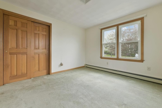unfurnished bedroom featuring carpet floors, baseboards, and a baseboard radiator