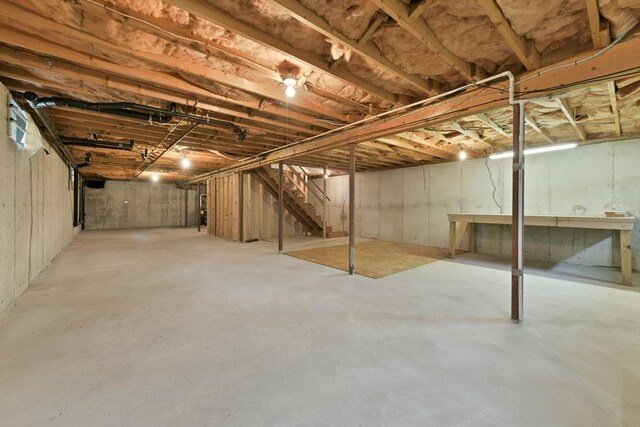 unfinished basement featuring stairway