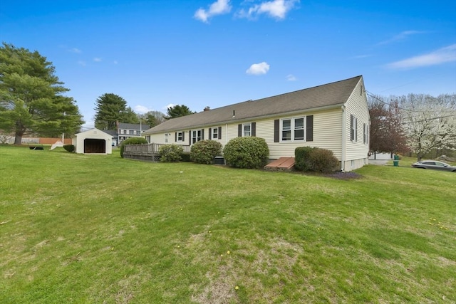 back of house with an outdoor structure and a yard