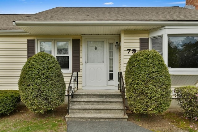 property entrance with roof with shingles