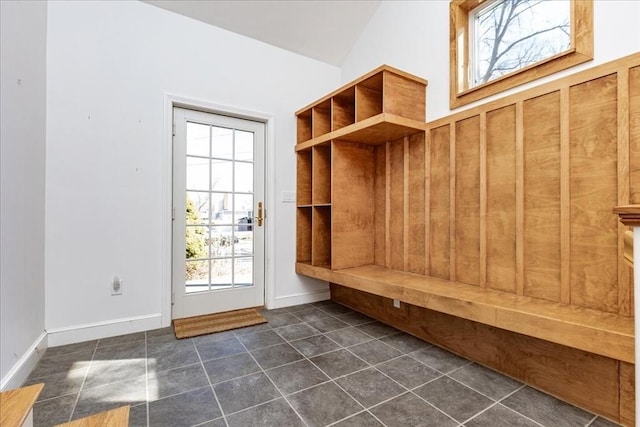 mudroom featuring dark tile patterned floors and baseboards