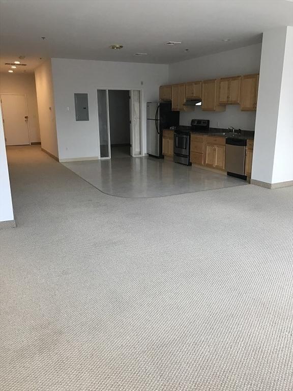 531 Main St Unit 203, Worcester, MA 01608 - kitchen with appliances with stainless steel finishes, electric panel, open floor plan, and baseboards