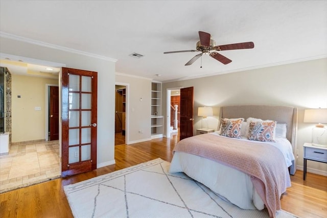 bedroom featuring a spacious closet, ceiling fan, hardwood / wood-style floors, a closet, and ornamental molding