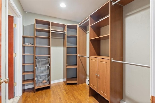 walk in closet featuring light hardwood / wood-style floors