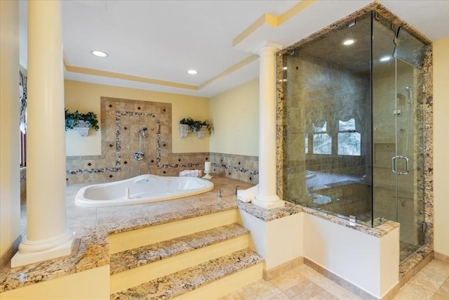 bathroom with ornate columns and independent shower and bath