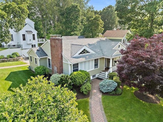 141 Cornell St, Newton, MA 02462 - view of front of home with a chimney, a front yard, and a shingled roof