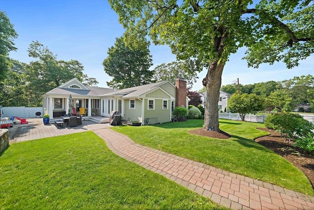 141 Cornell St, Newton, MA 02462 - rear view of property with a chimney and a patio area