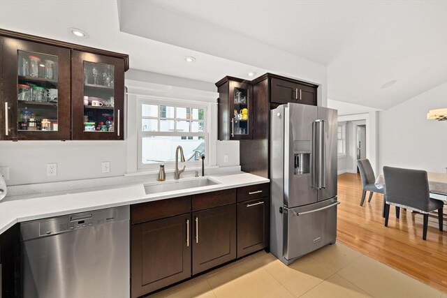 141 Cornell St, Newton, MA 02462 - kitchen with stainless steel appliances, dark brown cabinets, light countertops, glass insert cabinets, and lofted ceiling