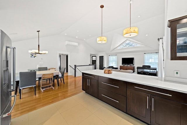 141 Cornell St, Newton, MA 02462 - kitchen featuring stainless steel fridge, lofted ceiling, light countertops, dark brown cabinetry, and open floor plan