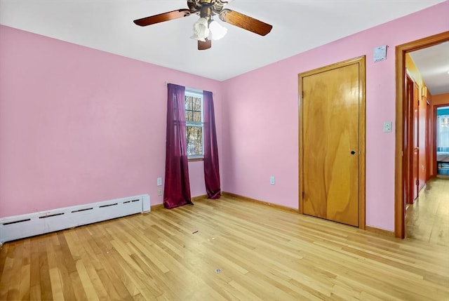 unfurnished bedroom with a baseboard radiator, ceiling fan, and light hardwood / wood-style flooring