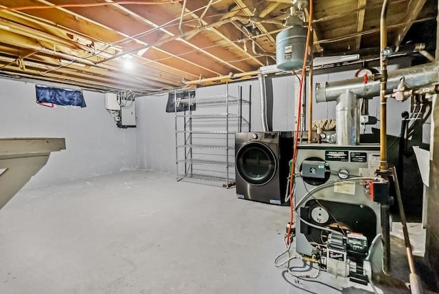 basement with electric panel and washer / dryer