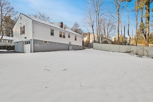 view of snow covered back of property