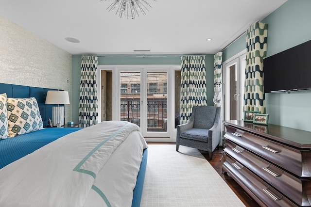 bedroom featuring french doors, access to outside, and dark hardwood / wood-style floors