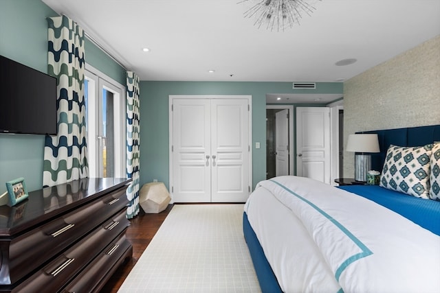 bedroom featuring a closet and dark hardwood / wood-style floors