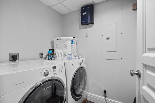 clothes washing area featuring independent washer and dryer and electric panel