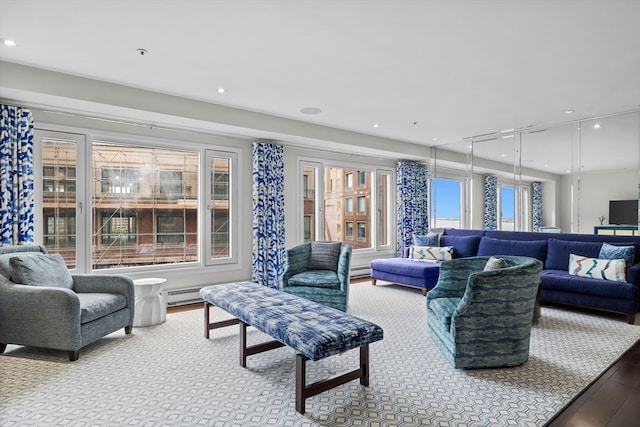 living room with light hardwood / wood-style floors and a baseboard heating unit