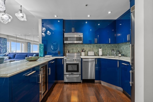 kitchen with blue cabinets, stainless steel appliances, and dark hardwood / wood-style floors