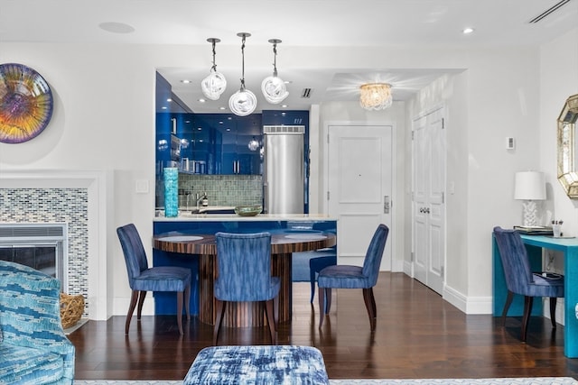 dining room with dark hardwood / wood-style flooring