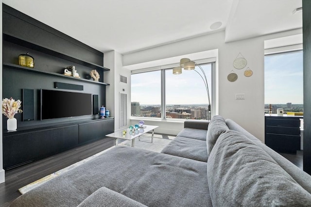 living room with dark hardwood / wood-style flooring and built in features