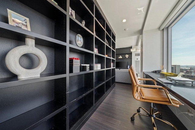 office area with dark hardwood / wood-style floors and built in features