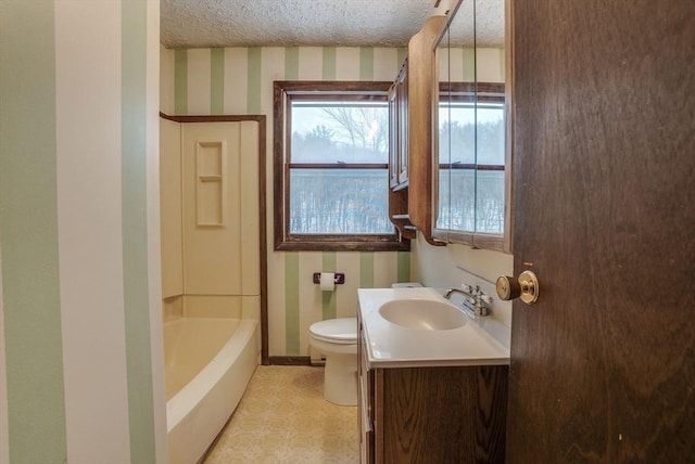 bathroom with toilet, vanity, and a textured ceiling