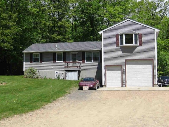 view of front of home with a front yard and a garage