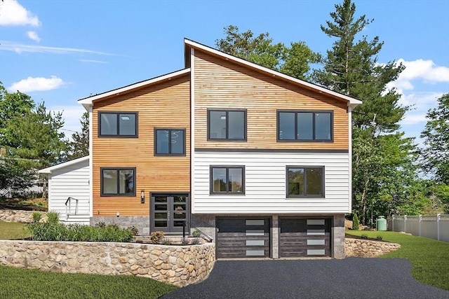 122 Charles St, Reading, MA 01867 - view of front of house with an attached garage and asphalt driveway