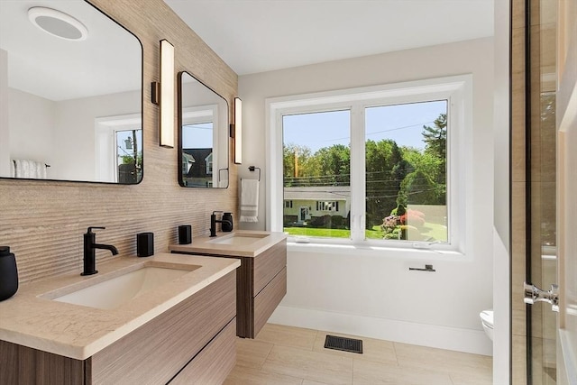 122 Charles St, Reading, MA 01867 - full bath featuring backsplash, baseboards, vanity, toilet, and tile patterned floors