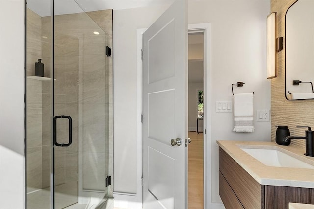 122 Charles St, Reading, MA 01867 - bathroom with a shower stall, vanity, and tasteful backsplash