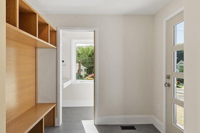 122 Charles St, Reading, MA 01867 - mudroom with tile patterned flooring and baseboards