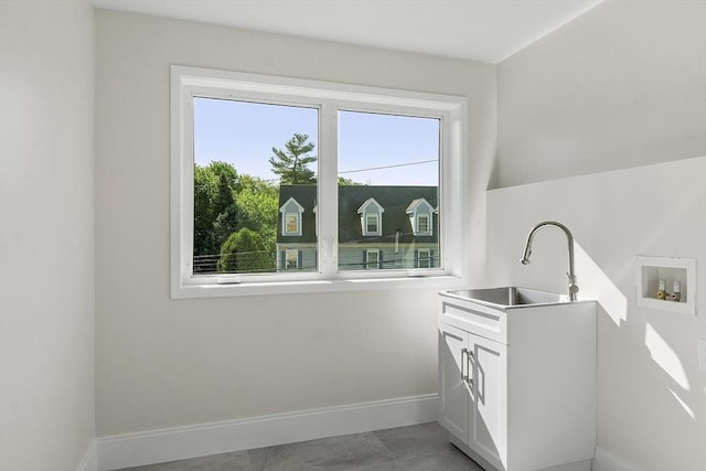 122 Charles St, Reading, MA 01867 - laundry area featuring baseboards, hookup for a washing machine, cabinet space, and light tile patterned flooring
