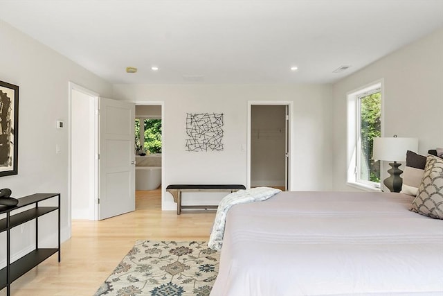 122 Charles St, Reading, MA 01867 - bedroom with multiple windows, light wood-style floors, recessed lighting, and baseboards