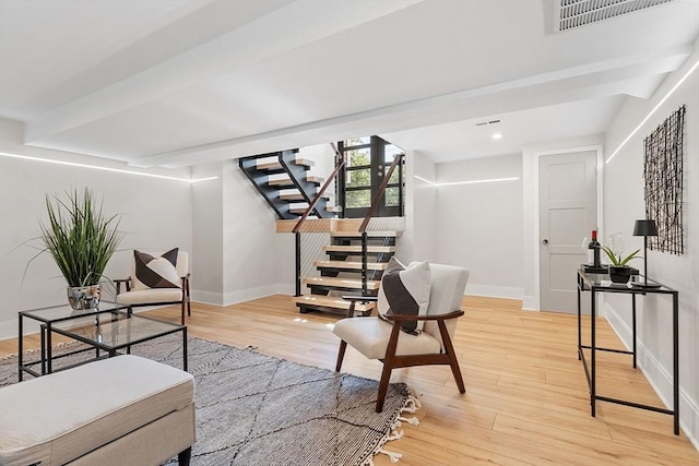 122 Charles St, Reading, MA 01867 - living area with stairway, light wood finished floors, baseboards, and recessed lighting