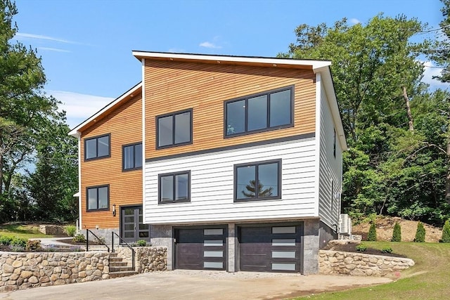 122 Charles St, Reading, MA 01867 - view of front of house featuring an attached garage and driveway