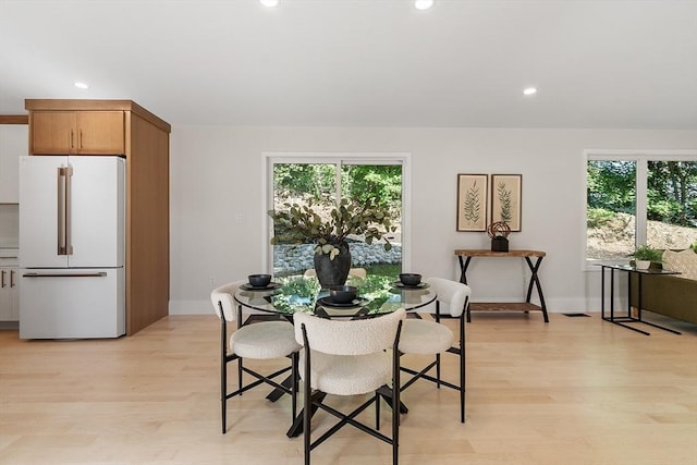 122 Charles St, Reading, MA 01867 - dining space with light wood finished floors, recessed lighting, healthy amount of natural light, and baseboards