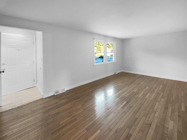 empty room featuring dark wood-type flooring