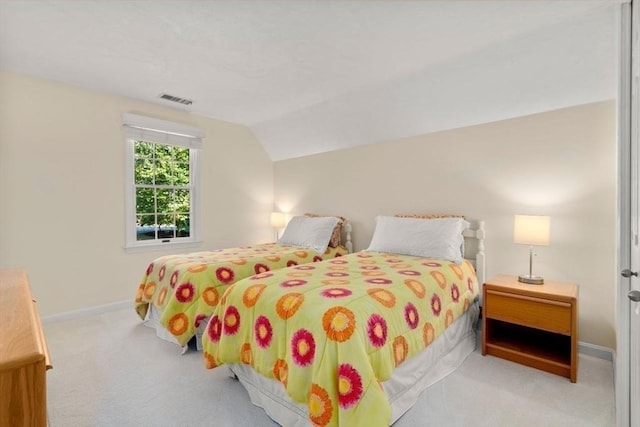 carpeted bedroom featuring baseboards, visible vents, and lofted ceiling