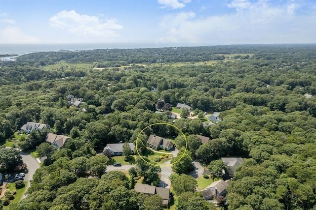 drone / aerial view featuring a wooded view