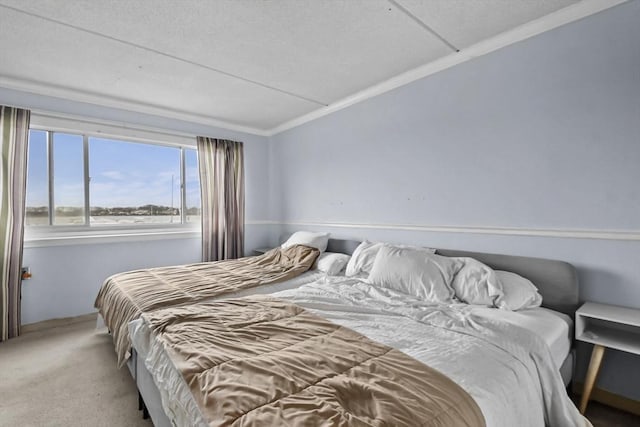 carpeted bedroom featuring crown molding