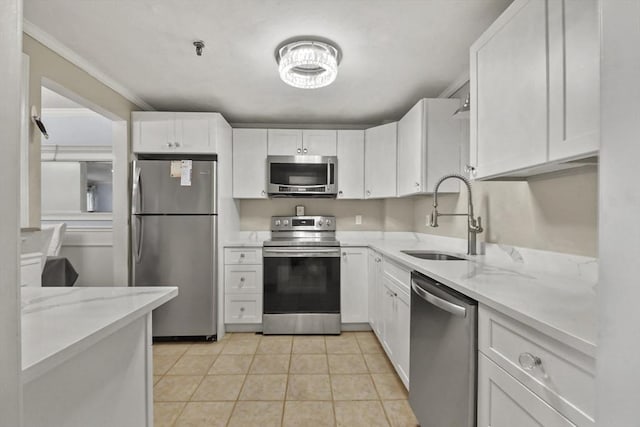 kitchen featuring light stone countertops, white cabinetry, sink, and stainless steel appliances