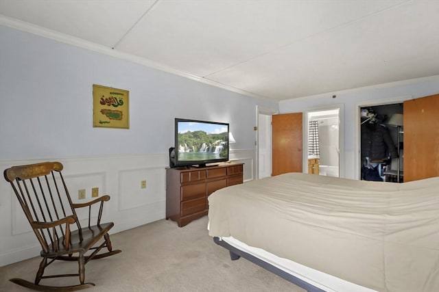 bedroom with light colored carpet, a spacious closet, a closet, and ornamental molding